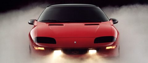 Older red car modernized with new technology