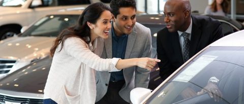 Customers and Salesperson discussing whether to lease or buy
