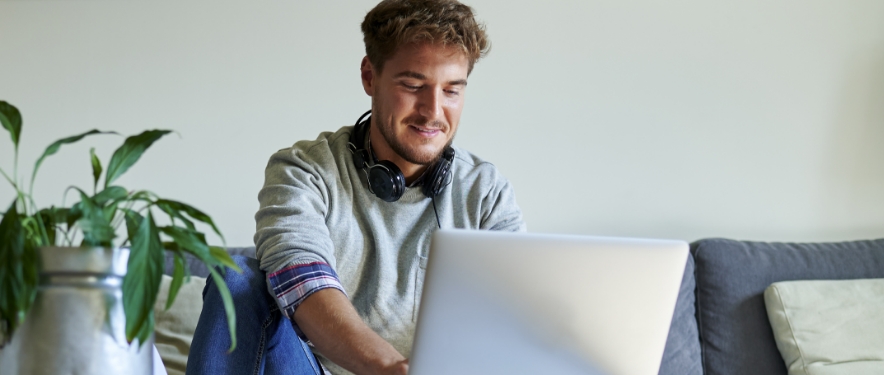 Person managing their GM Financial account using MyAccount on their laptop at home.